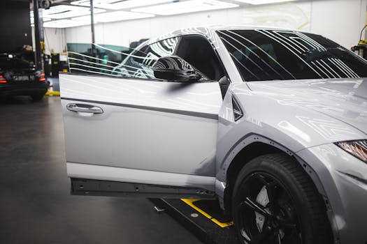 pexels-photo-10126667-10126667 Luxury vehicle undergoing service in a well-lit auto repair shop, showcasing sleek design and glossy finish.