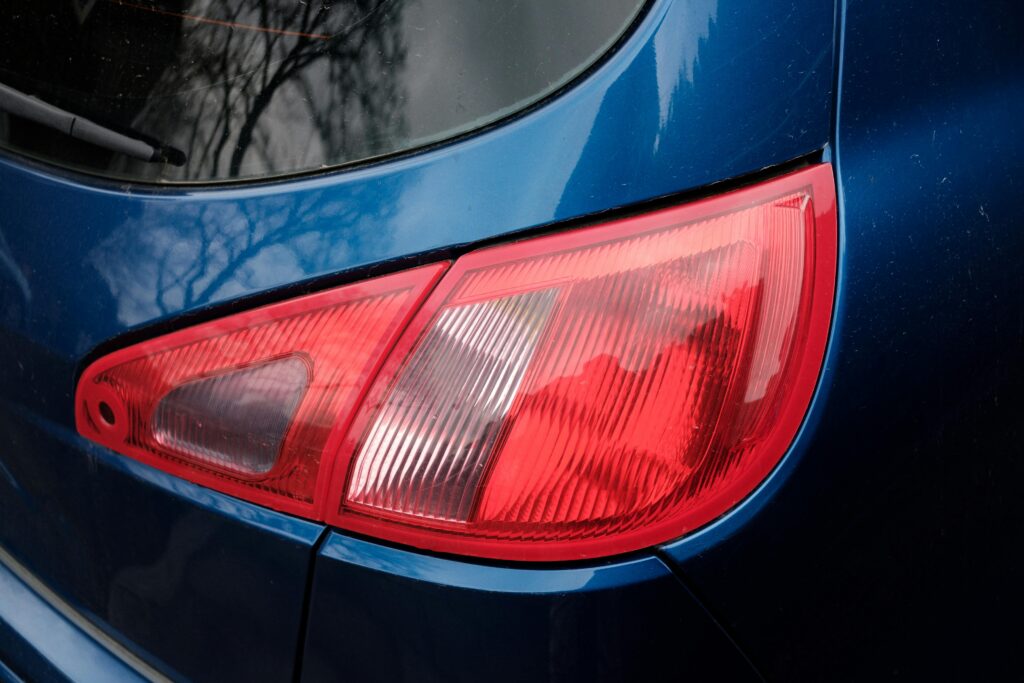 Detailed close-up of a blue car's modern and shiny taillight exterior.